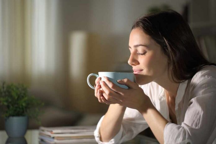 Relaxed,Woman,Smelling,Coffee,In,The,Morning,Sitting,In,The