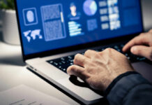 Stunning Link: Dental Health and Heart Disease Close-up of hands typing on a laptop with data visualizations on the screen