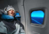 Deep Sleep REORGANIZES What Matters Most A passenger sleeping on an airplane with headphones and an eye mask