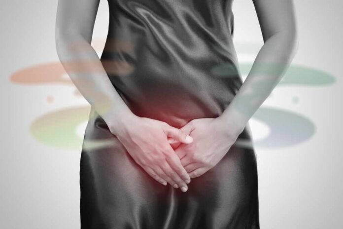 Woman in a black dress holding her stomach, indicating discomfort