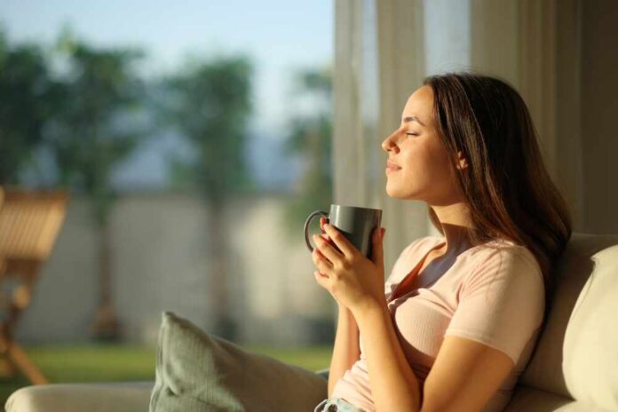 shutterstock_2522238619.jpg Woman enjoying a cup of coffee in a sunlit room