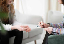 The Secret to Beating Clutter Two individuals engaged in a counseling session, one taking notes