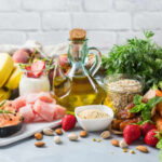 The Fat That Turns Off Inflammation A variety of fresh foods including fruits, vegetables, and oils arranged on a table