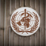 World Health Organization emblem featuring a globe and caduceus
