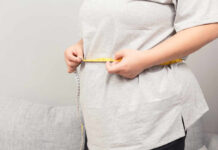 Obesity’s Gender Divide: What Doctors Miss Person measuring their waist with a tape measure