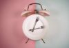 An alarm clock with a plate and two forks arranged in a creative design