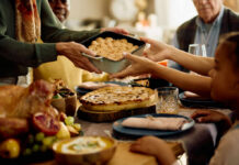 A family sharing a dish during a festive meal