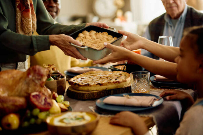 A family sharing a dish during a festive meal