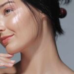 Close-up portrait of a woman with glowing skin and a gentle smile