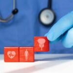 The Surprising Anti-Inflammatory Power Duo A doctor's gloved hand placing red blocks with health symbols on a table