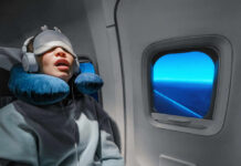 Surprising Sleep Pattern That TRIPLES Dementia Risk! A passenger sleeping on an airplane with headphones and an eye mask