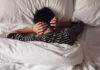 Common Sleep Habit That DESTROYS Your Immunity Child lying in bed with hands over ears