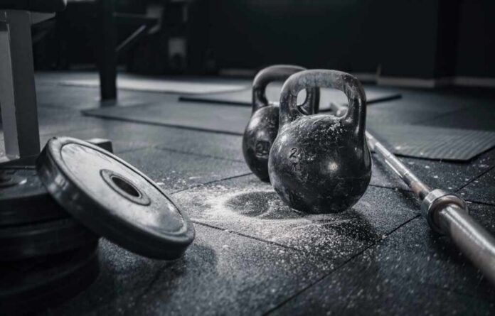 Sports,Background.,Weight,Lifting,Training. Kettlebells and weights on a gym floor with chalk dust