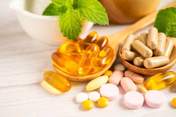 Alternative,Medicine,Herbal,Organic,Capsule,With,Vitamin,E,Omega,3 Assorted vitamins and supplements arranged with mint leaves