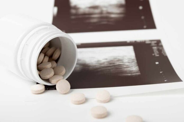 Spilled pills beside medical imaging prints