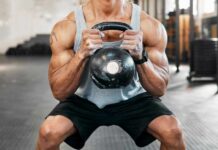 Athlete performing a kettlebell squat in a gym