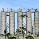 Metal storage silos against a blue sky