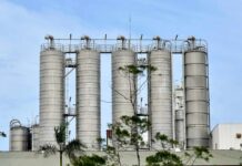 Coal Mines Linked to Mysterious Cancer Surge Metal storage silos against a blue sky