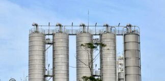 Metal storage silos against a blue sky