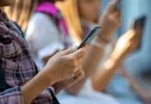 What Excessive Screen Time Does to your Brain Hands of young people using smartphones
