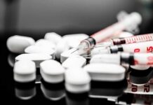 What a Rutgers Study Found About Ozempic And Violence White pills and syringes arranged on a reflective surface