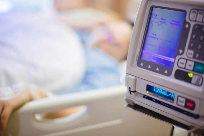 shutterstock1449440597jpg IV pump displaying medication flow rate in a hospital room