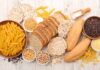 Best Carbs for Muscle Building: Experts Weigh In Assorted grains and breads on a wooden table