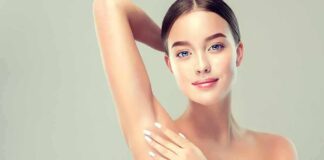 Woman touching smooth underarm with raised arm