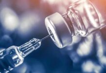 Hybrid Immune Hack Reverses Type 1 Diabetes syringe needle drawing liquid from a vaccine vial
