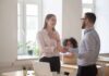 coworkers shaking hands in a bright office