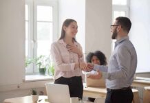 Trauma Playbook Hiding Behind “Chronic Niceness” coworkers shaking hands in a bright office