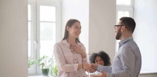 coworkers shaking hands in a bright office