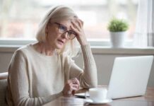 How to Improve Your Memory and Cognitive Function at Any Age Older woman with glasses looking concerned at laptop