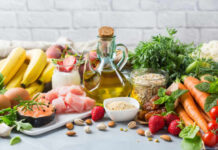 Pre-Bed Nutrient That Outsmarts Insomnia A variety of fresh foods including fruits, vegetables, and oils arranged on a table