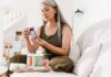 Creatine Beyond the Gym – What Older Women Should Know Woman reading a supplement bottle on a couch