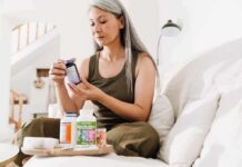 Creatine Beyond the Gym – What Older Women Should Know Woman reading a supplement bottle on a couch