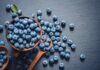 Blueberries vs. Grapes: Which Is Better for Heart Health? A bowl of fresh blueberries on a dark surface