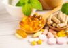 Assorted vitamins and supplements arranged with mint leaves