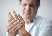 Doctors Flip Script On Arthritis Pain Man holding his hand in discomfort