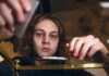 How The Wrong Zip Code Derails Addiction Recovery young person leaning over a table with hands arranging items
