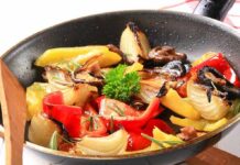 Hot Pepper Habit, Cold Cancer Warning! A skillet filled with colorful stir-fried vegetables including onions and bell peppers