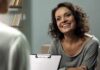 Trapped in Constant Survival Mode? Smiling woman talking during a meeting