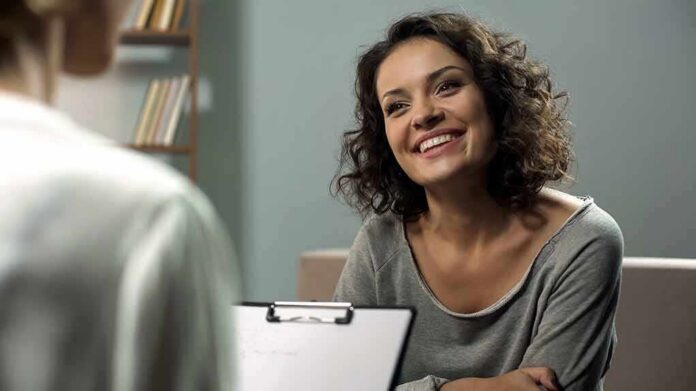 shutterstock_1204439644-1 Smiling woman talking during a meeting