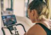 How Much Weight You Can Actually Lose in a Week Woman on stationary bike watching a screen