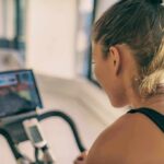 Woman on stationary bike watching a screen