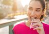 Woman eating a granola bar outdoors