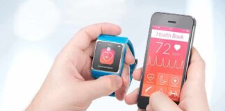 hands holding a smartwatch and a smartphone with health app