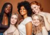 Group portrait of five women smiling together