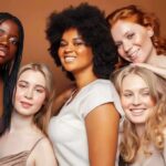 Group portrait of five women smiling together
