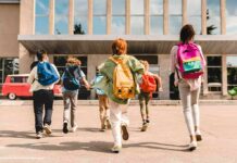 Childhood Trauma’s Surprise Fix Group of schoolchildren with backpacks running toward a school entrance
